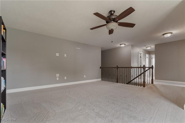 spare room featuring carpet flooring and ceiling fan