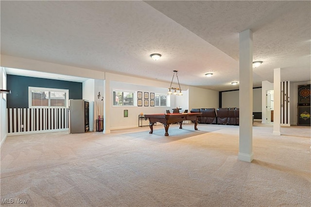 rec room featuring a healthy amount of sunlight, a textured ceiling, pool table, and light carpet