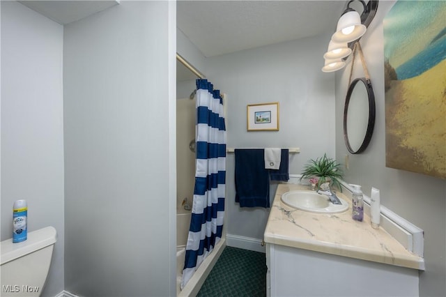 bathroom with a shower with curtain, vanity, toilet, and tile patterned floors