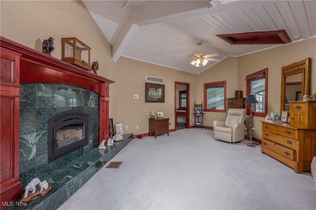 living area with a premium fireplace, ceiling fan, light carpet, and vaulted ceiling