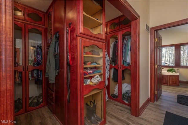 hallway with hardwood / wood-style floors