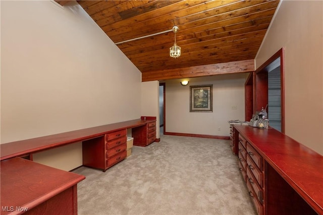 interior space with wood ceiling, light carpet, built in desk, and lofted ceiling