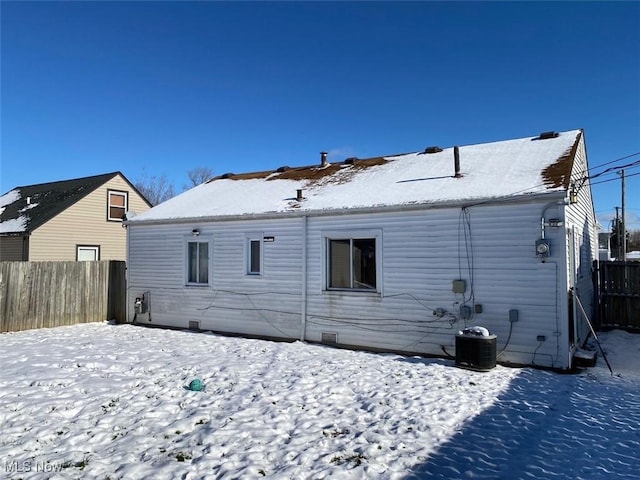 snow covered property featuring cooling unit