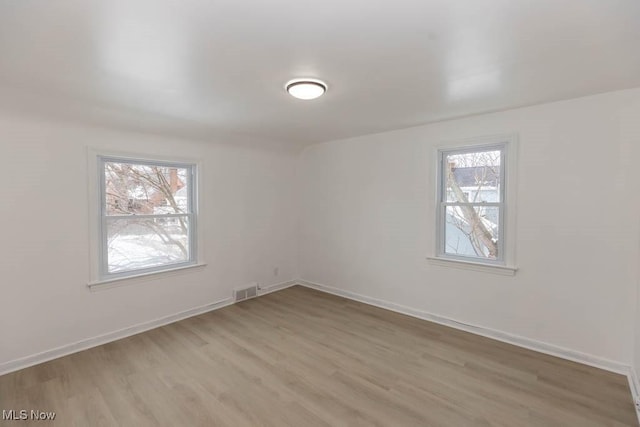 empty room with light hardwood / wood-style floors