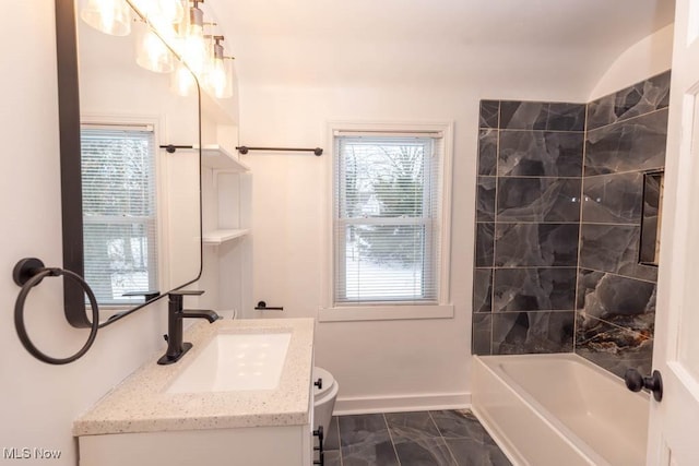 full bathroom featuring vanity, toilet, and tiled shower / bath combo