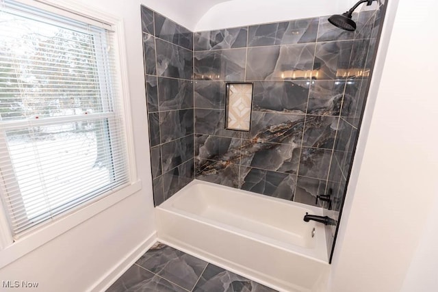 bathroom with plenty of natural light and tiled shower / bath combo