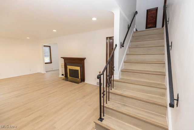 staircase featuring wood-type flooring