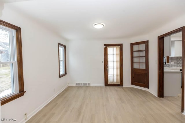 empty room with light hardwood / wood-style flooring