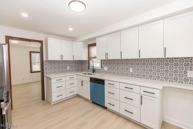 kitchen featuring white cabinets, appliances with stainless steel finishes, light hardwood / wood-style floors, and sink