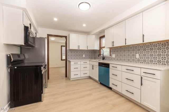 kitchen featuring white cabinets, stainless steel appliances, light hardwood / wood-style flooring, and sink