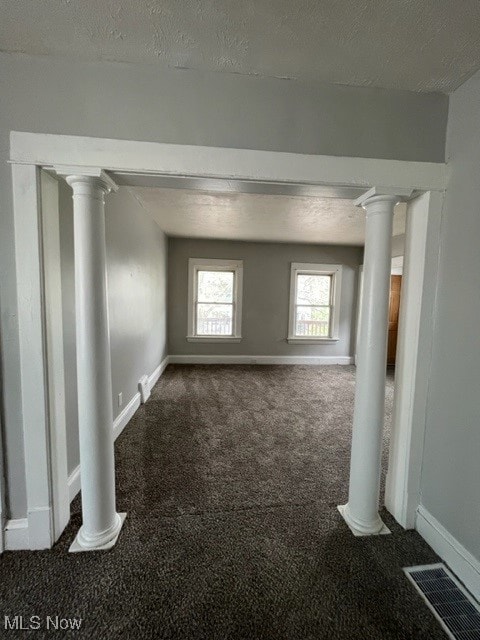 carpeted spare room with a textured ceiling