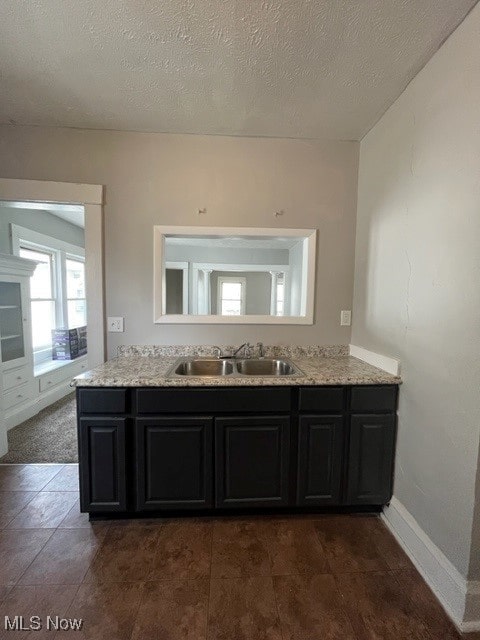 bathroom featuring a textured ceiling and vanity