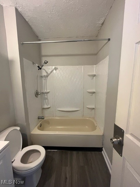 full bathroom featuring a textured ceiling, shower / tub combination, vanity, toilet, and hardwood / wood-style flooring