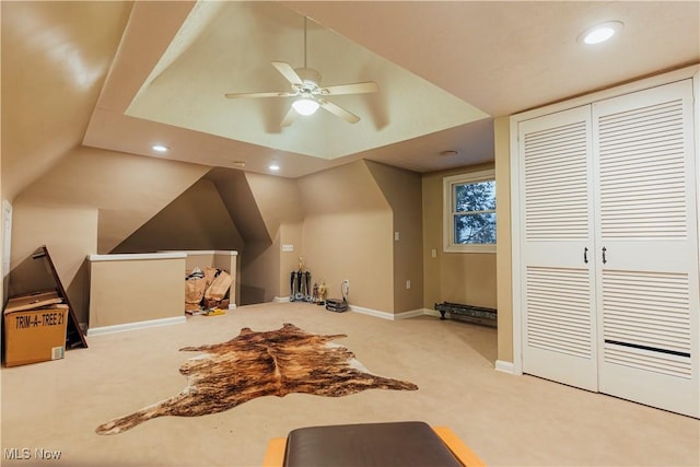 additional living space with light colored carpet, vaulted ceiling, and ceiling fan