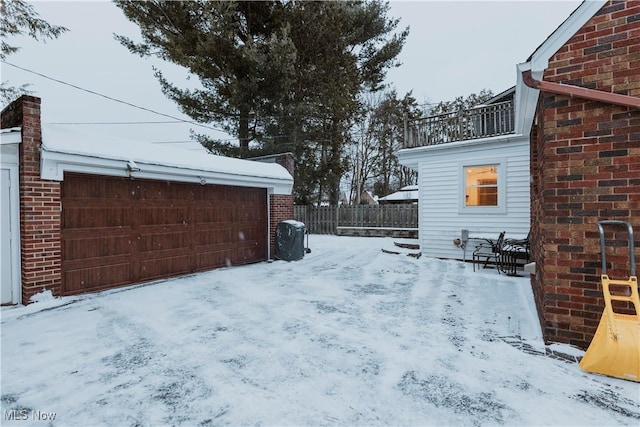 snowy yard featuring a balcony