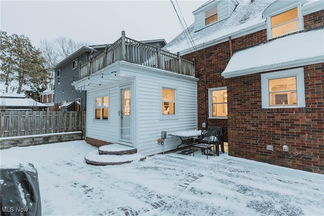 snow covered house with a balcony