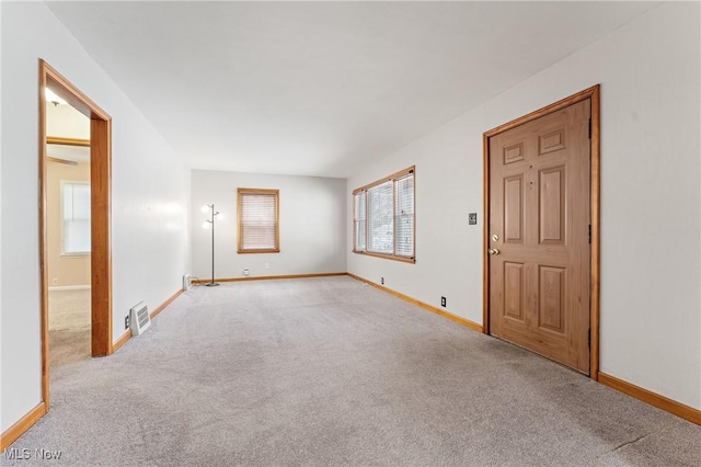 spare room with light colored carpet