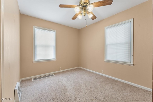 carpeted empty room featuring ceiling fan