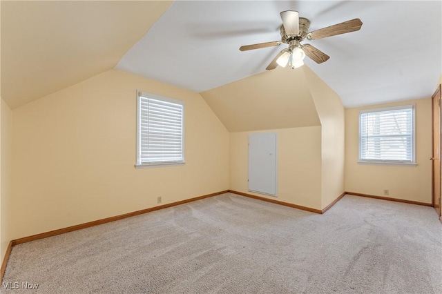 additional living space with ceiling fan, light carpet, and vaulted ceiling