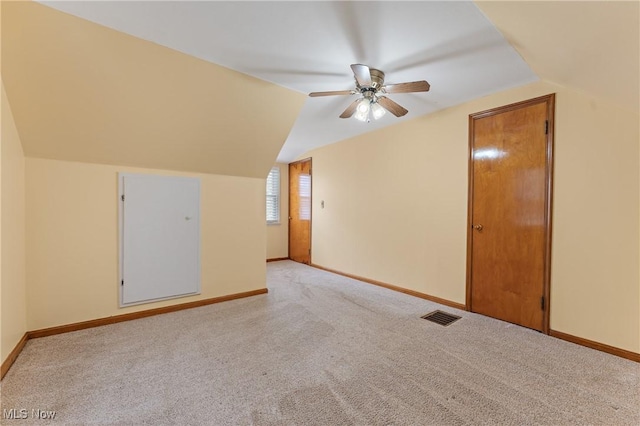 additional living space with light carpet, vaulted ceiling, and ceiling fan