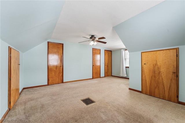 additional living space with ceiling fan, light colored carpet, and lofted ceiling