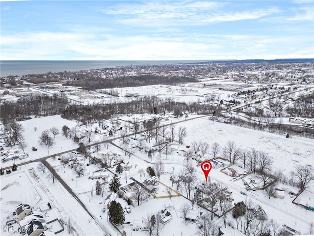 snowy aerial view featuring a water view