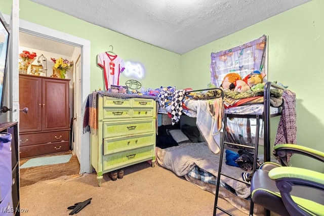 bedroom with light carpet and a textured ceiling