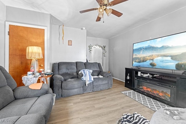 living room with ceiling fan and light hardwood / wood-style flooring