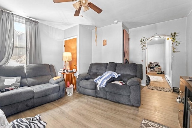 living room featuring ceiling fan and light hardwood / wood-style floors