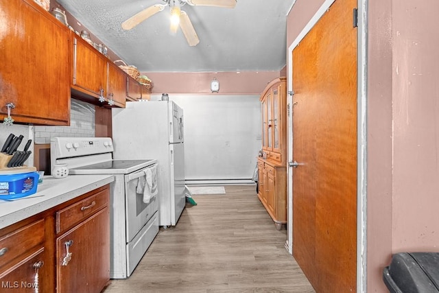 kitchen featuring ceiling fan, light hardwood / wood-style flooring, a baseboard heating unit, backsplash, and electric stove