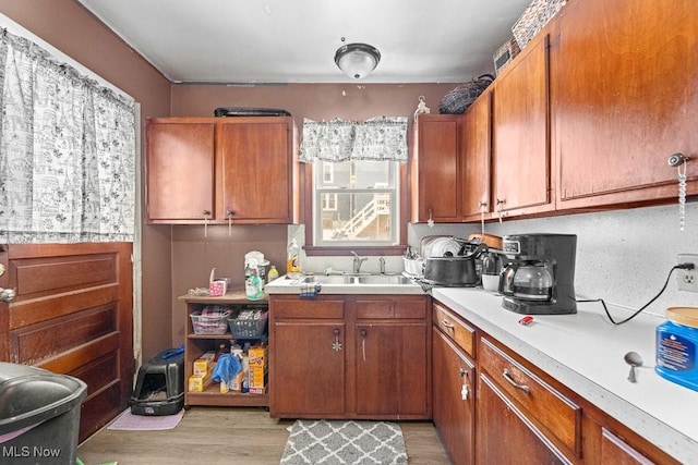 kitchen with light wood-type flooring and sink