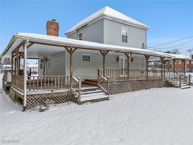 snow covered property featuring covered porch