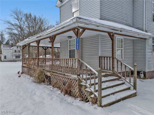 view of snow covered property entrance