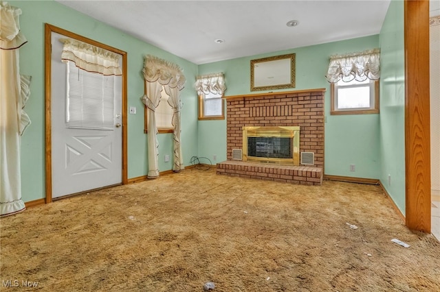 unfurnished living room with carpet flooring and a brick fireplace