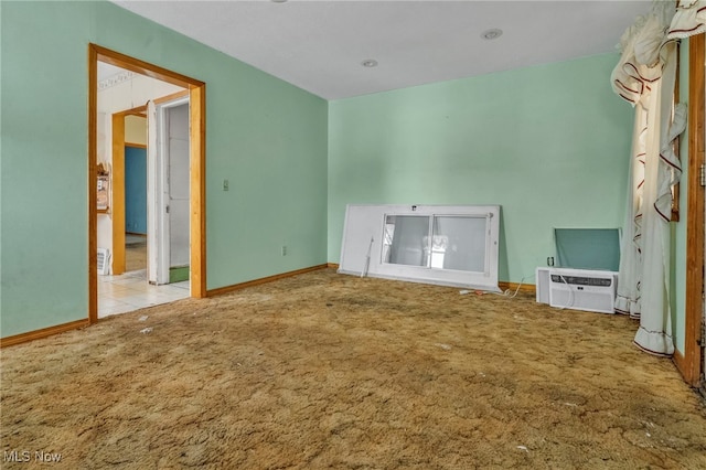 interior space with a wall unit AC and light carpet