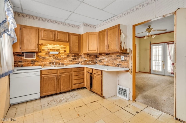 kitchen featuring light carpet, a paneled ceiling, ceiling fan, sink, and dishwasher