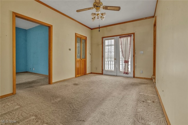 spare room with ceiling fan, french doors, carpet, and crown molding