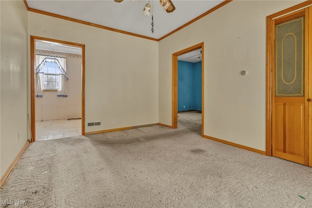 carpeted spare room featuring ceiling fan and ornamental molding