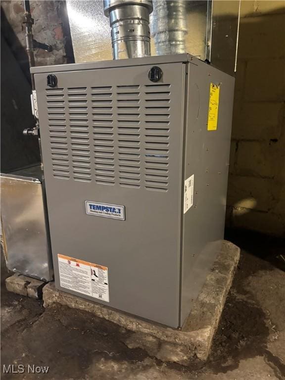 utility room featuring heating unit