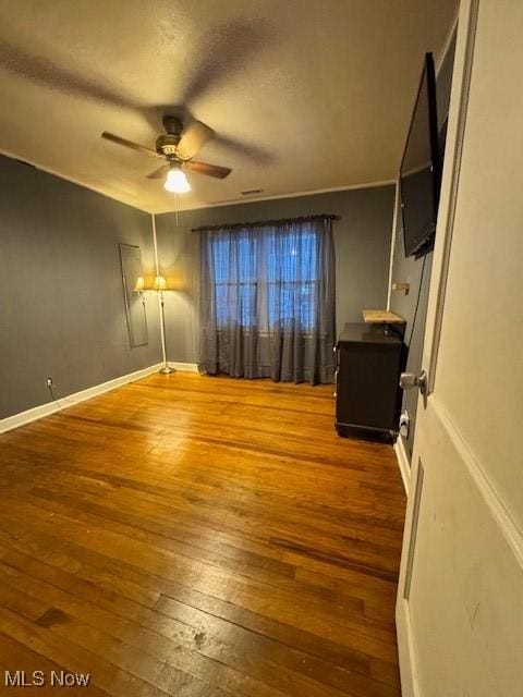 unfurnished bedroom featuring wood-type flooring and ceiling fan