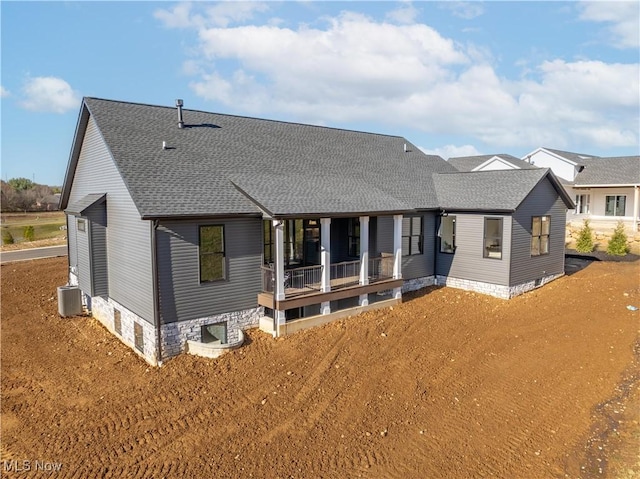 rear view of property with a porch and central AC