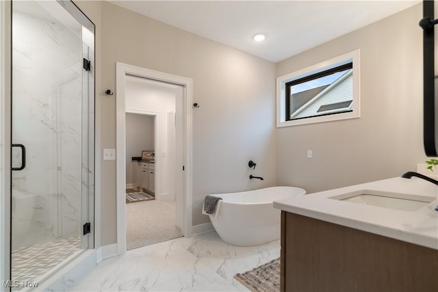 bathroom with vanity and separate shower and tub