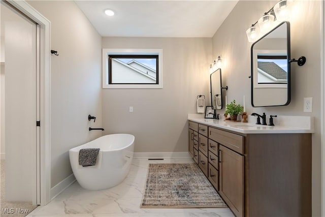 bathroom featuring vanity and a tub to relax in