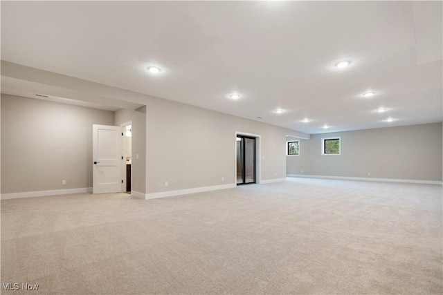 basement featuring light colored carpet