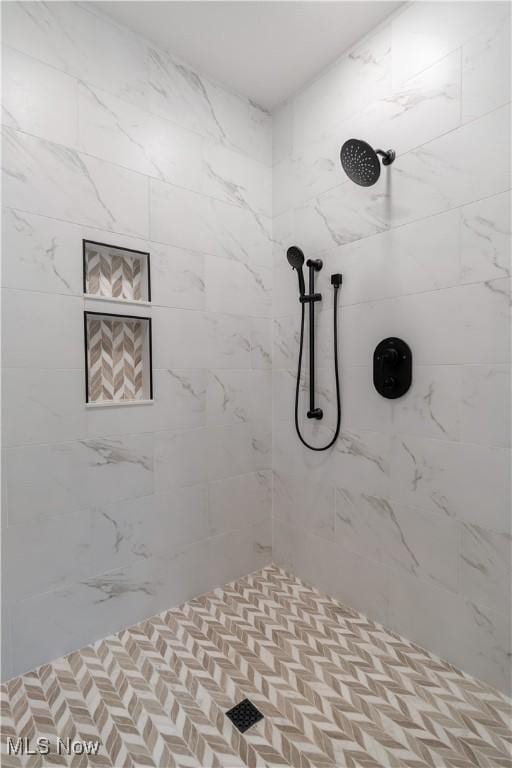 bathroom with a tile shower