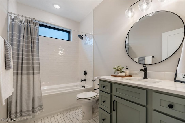 full bathroom with shower / tub combo with curtain, vanity, and toilet