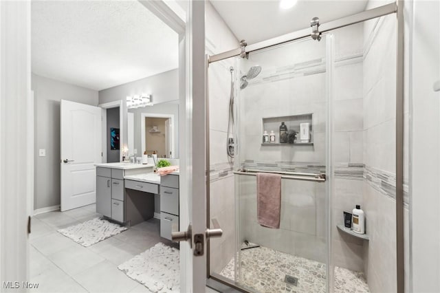 bathroom featuring vanity, tile patterned floors, and a shower with shower door