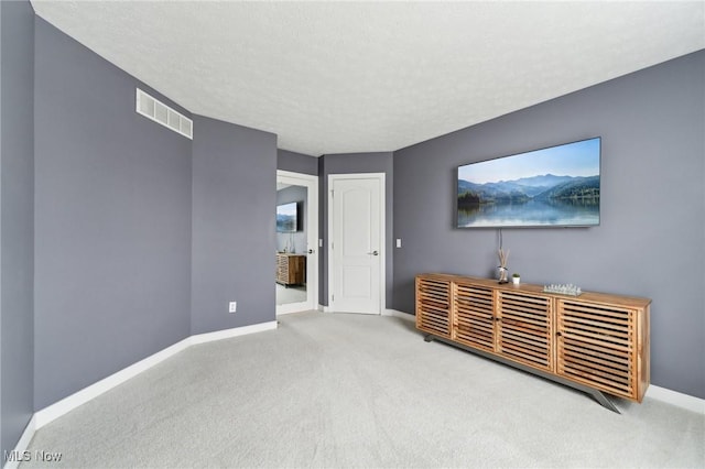 living room featuring carpet flooring and a textured ceiling