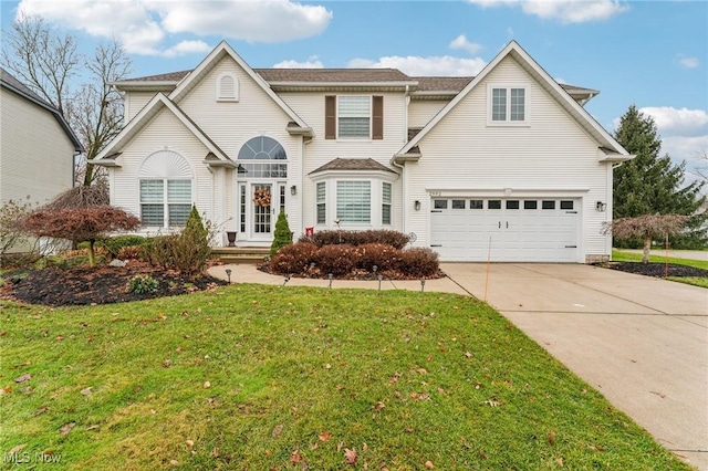 view of front property with a garage and a front lawn