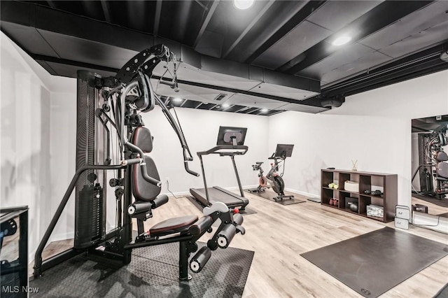 workout area with hardwood / wood-style floors